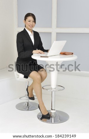 Japanese business woman at office desk with laptop