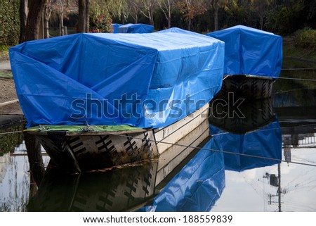 Boats covered with blue sheet