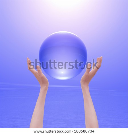 Hand and crystal ball with purple background