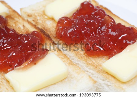 An image of Toast topped with jam and butter