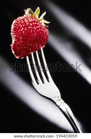 In strawberry ,black-back bites dessert fork