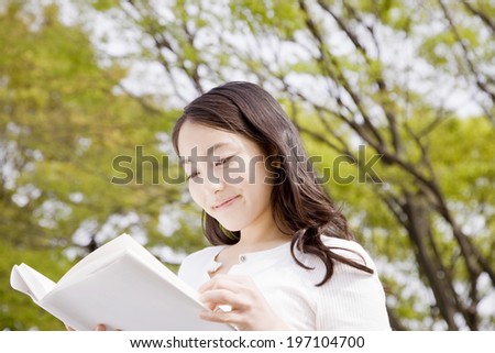 Woman Reading A Book Outside