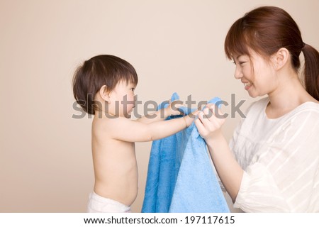 Mother Putting A Towel On Baby