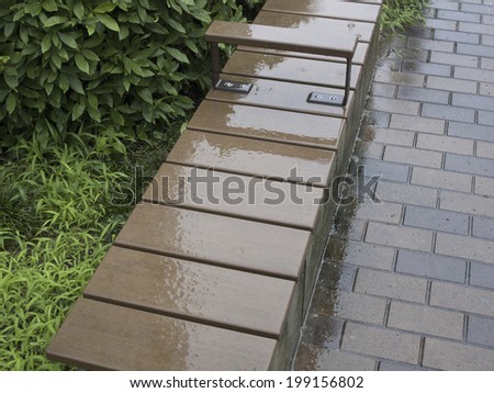 Wet Wooden Bench In The Rainy Park