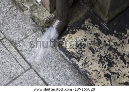 Rain Gutter With A Large Amount Of Rainwater Due To Heavy Rain