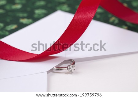 Red Ribbon And The Diamond Ring For Christmas Gift