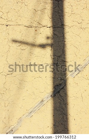Mud Wall Of The House With The Shadow Of The Pole