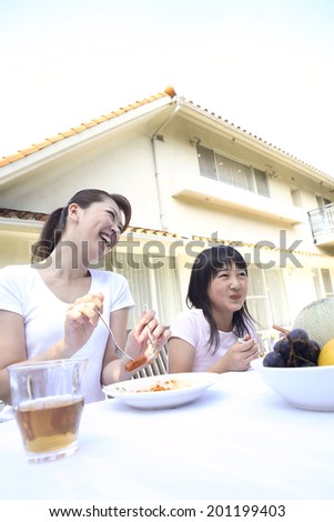 Parents and children eating outside