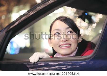 Woman watching illumination from inside the car