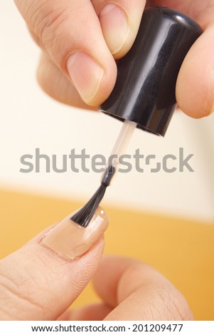 Finger of the woman painted nail polish