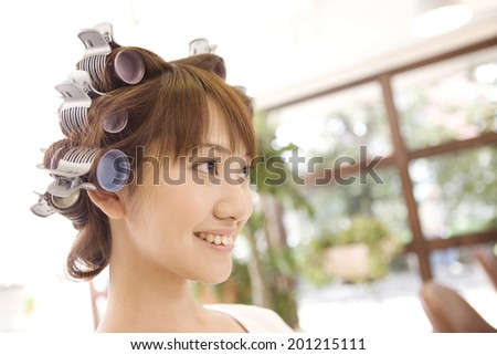 Woman getting a perm at hair salon