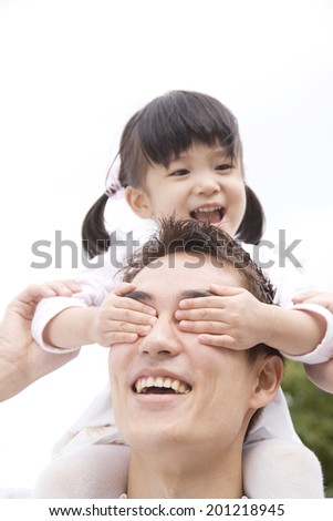 Girl is riding piggyback on father