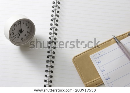 Watch And Notebook On The Top Of The Notebook