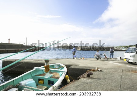 The Person Fishing In The Harbor