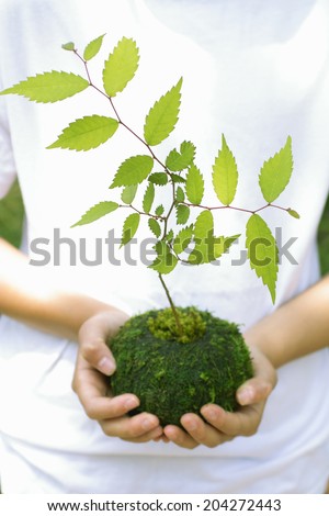 The Woman With The Moss Ball Which Is A Round Shape