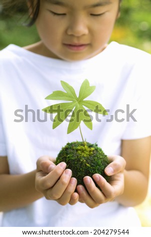 The Girl With The Moss Ball Which Is A Round Shape