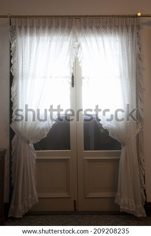 An Image of Door With Curtains
