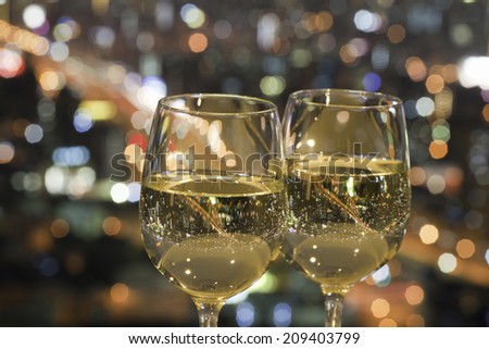 The Night View Of The City Reflected In The Glass Of Wine