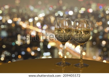 The Night View Of The City Reflected In The Glass Of Wine