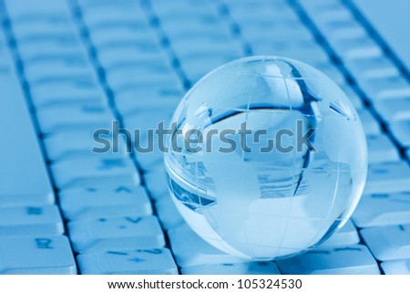 global communication  concept. Crystal-glass globe on the computer keyboard