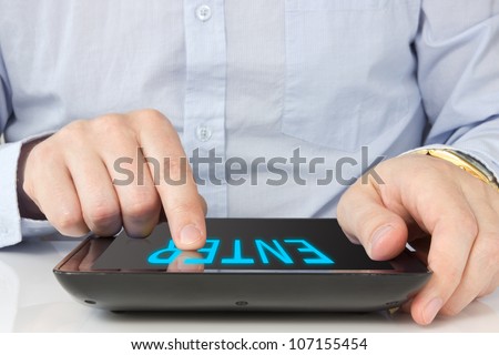 Businessman finger pointing to the screen of a tablet-pc