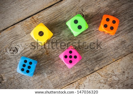 Colorful dice on the old wooden floor