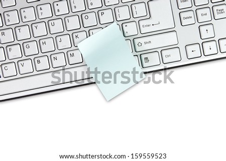 Computer keyboard and blank memo over a white background