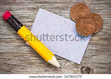 Copper euro cents with pencil and  paper card