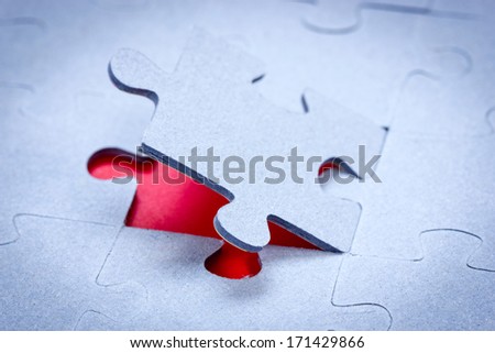 One piece of jigsaw revealing red background