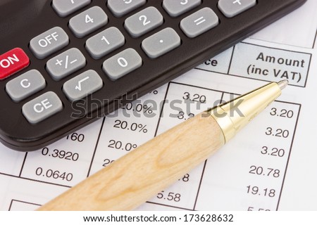 Calculator, pen and invoice with balance due