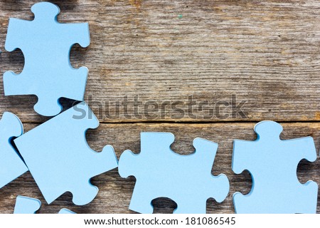 Puzzle on wooden boards.Team business concept