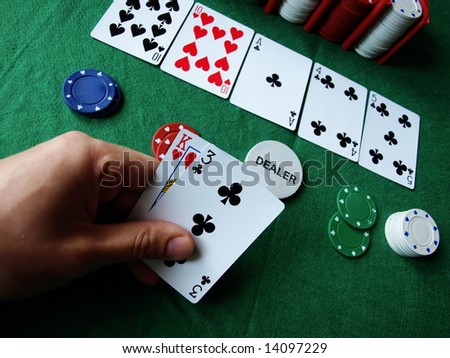 playing cards at human hand on the table