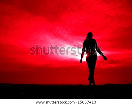 female silhouette on the red sky background