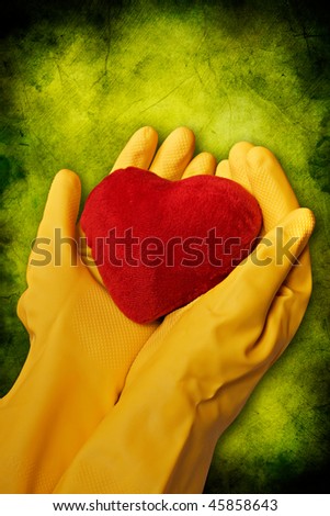 hands in yellow gloves hold red heart