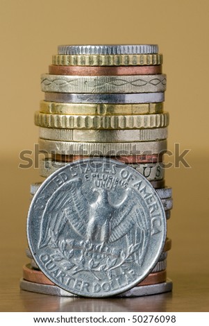 coins stack with quarter dollar in a front