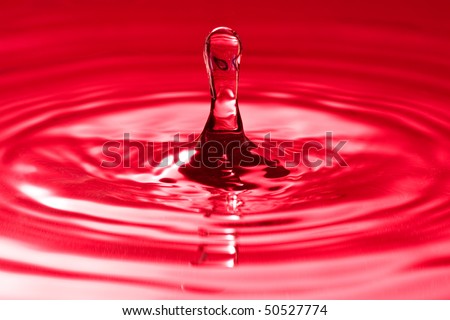 abstract quietness and balance.droplet splash in a red water