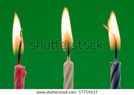 birthday candles , isolated over a green background