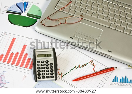 business concept. computer,glasses,calculator,pen and charts