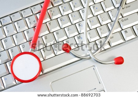 Concept for online medicine or IT support . Computer keyboard with a stethoscope.