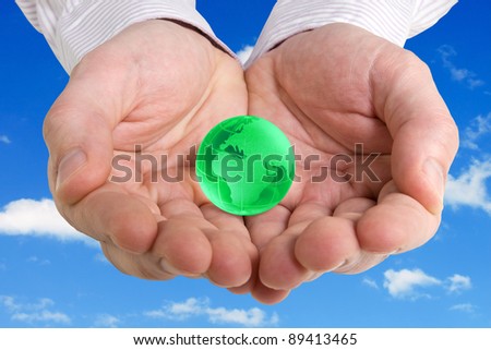 saving earth concept photo with hands holding a globe on the sky background