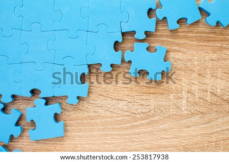Puzzle on wooden background.Team business concept
