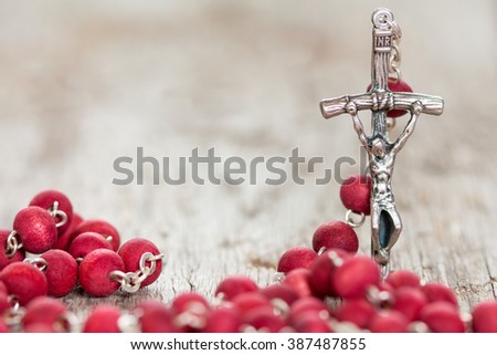 Catholic rosary on old wooden  background. Selective focus.