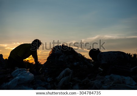silhouette of the sun rise in the morning at a garbage dump.