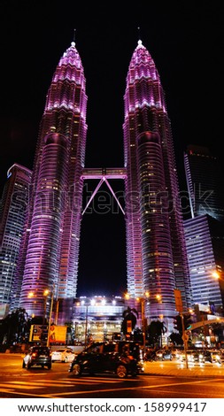 KUALA LUMPUR - OCT 19: Petronas Twin Towers illuminate in pink in conjunction of breast cancer campaign to raise awareness about breast health and early detection on October 19, 2013 in Kuala Lumpur