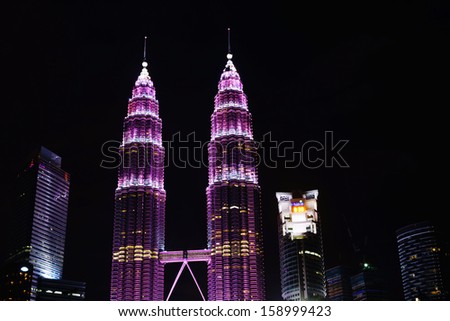KUALA LUMPUR - OCT 19: Petronas Twin Towers illuminate in pink in conjunction of breast cancer campaign to raise awareness about breast health and early detection on October 19, 2013 in Kuala Lumpur