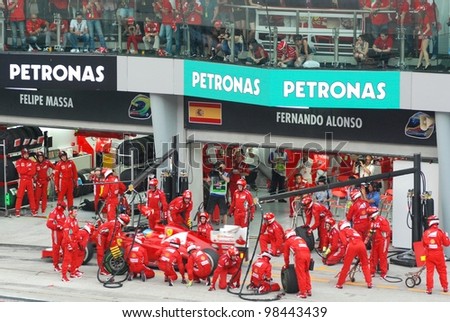 SEPANG, MALAYSIA - MARCH 25: Ferrari F1 Team crews does pit-stop practice at the 2012 F1 Petronas Malaysian Grand Prix at Sepang International Circuit on March 25, 2012 in Sepang, Malaysia