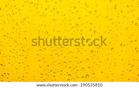 water drops rain on mirror background with yellow.