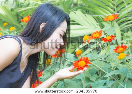 beautiful Asian woman in a flower garden, cute female enjoying smell of flower, beautiful teenager girl with closed eyes relaxed in flowers garden, spring nature, the happiest, (Thailand girls)