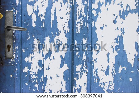 Old blue wooden door with peeling paint