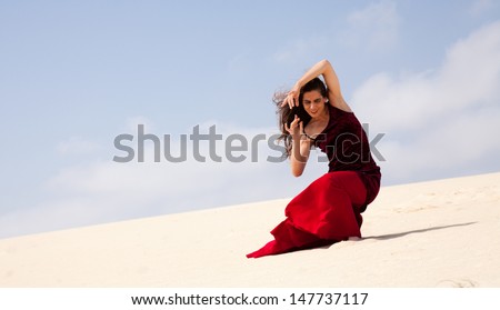 Flamenco dancer in the long dress in the dunes